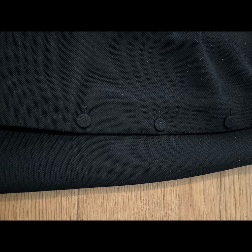 A black textured skirt with a faux wrap designed by Reiss of London.
